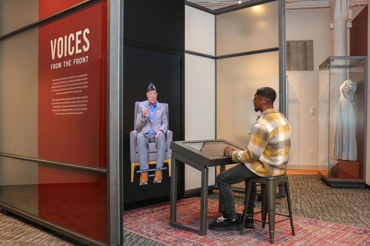 Devin Dumas speaks with a video image of the late World War II veteran Hershel “Woody” Williams as part of the new Voices From the Front exhibit at the National WWII Museum in New Orleans. 