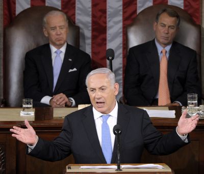 Israeli Prime Minister Benjamin Netanyahu addresses Congress on Tuesday in Washington. Vice President Joe Biden and House Speaker John Boehner listen. (Associated Press)