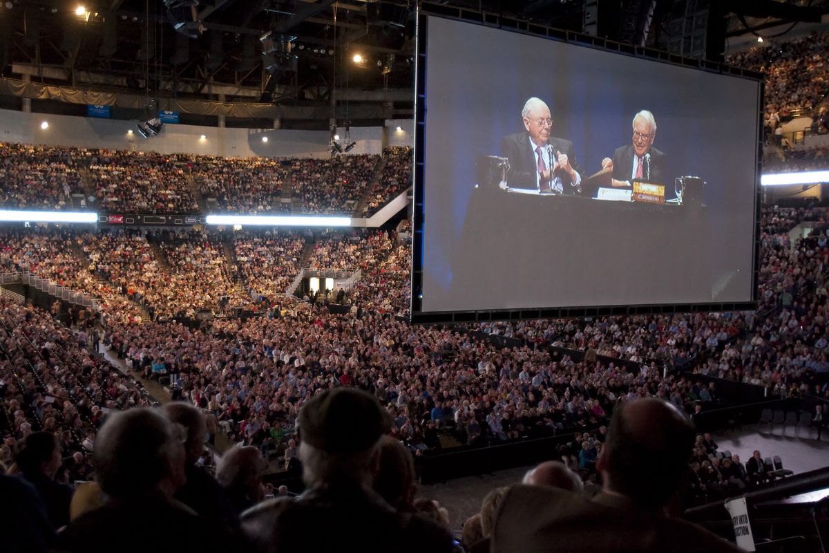 Warren Buffett, CEO of Berkshire Hathaway, right, and Charlie Munger,  vice chairman, are projected on a large screen at the annual  shareholders meeting in Omaha, Neb., on Saturday. Associated Press photos (Associated Press photos / The Spokesman-Review)