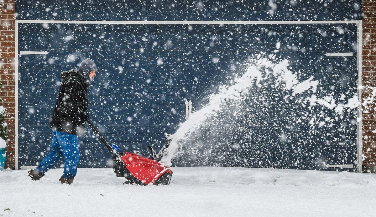 Tom McCulloch battles the Wednesday storm that dumped several inches of snow as he blows six driveways for his South Hill neighborhood near Chase Middle School, Nov.30, 2022 in Spokane.  (DAN PELLE/THE SPOKESMAN-REVIEW)