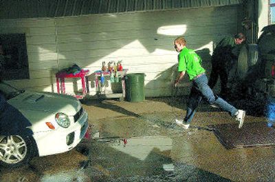 
Colt Dial sprints towards his next car for hand drying Friday at Gentle Touch Hand Wash in Spokane. Dial estimated some 250 cars will have been washed by closing time. 
 (Photos by BRIAN PLONKA / The Spokesman-Review)