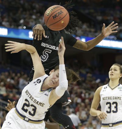 South Carolina guard Khadijah Sessions (5) jumps for a loose ball as Notre Dame guard Michaela Mabrey (23) falls. (Associated Press)