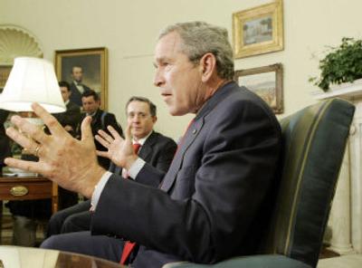 
President Bush talks to reporters Thursday while meeting with President Alvaro Uribe of Colombia at the White House. Bush said Saturday's shooting was 