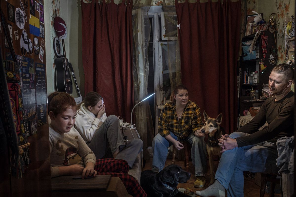 Oleksandra Kovalenko, center, who is anxious about the possibility of a winter without gas for their stove and radiators, sits with her husband and children on Nov. 4 at their home in Kyiv. Through four years of Russian attacks, many Ukrainians adapted to life with intermittent or no electricity, but the Kremlin is now targeting Ukraine’s heating gas infrastructure, a critical lifeline in winter.  (New York Times )