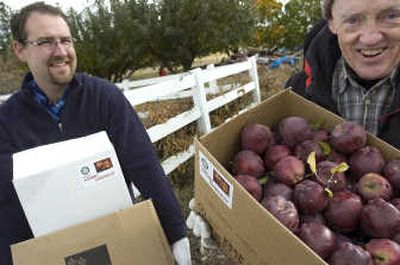 
Ben Nielsen, left, and Jim Roeber, join other Rotary members Oct. 19 collecting apples for Second Harvest and distribution to food banks in the area. The program, dubbed Rotary Home Harvest, works both commercial and home orchards.
 (Photo by Christopher Anderson / The Spokesman-Review)