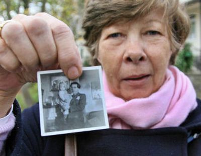
A Lebensborn Kinder in childhood, Violetta Wallenborn shows a photo of herself in her father's arms during a Saturday visit to the former Lebensborn home Wernigerode, eastern Germany. 
 (Associated Press / The Spokesman-Review)