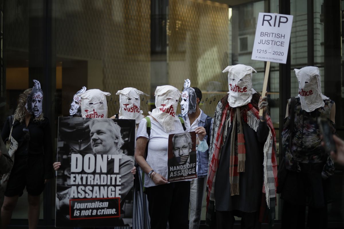 Supporters of WikiLeaks founder Julian Assange take part in a protest outside the Central Criminal Court, the Old Bailey, in London, Monday, Sept. 14, 2020. The London court hearing on Assange