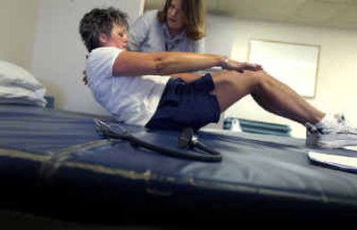 
Kathy Murphy, left, works with exercise physiologist Debbie Notrica during her workout with the cancer fitness recovery program at St. Luke's Rehabilitation Institute earlier this month.
 (Christopher Anderson/ / The Spokesman-Review)