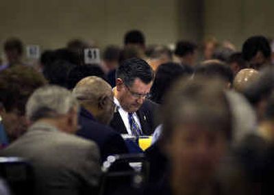 
Mayor Jim West bows his head in prayer during the annual Leadership Prayer Breakfast at the Spokane Convention Center on Friday morning.
 (Jed Conklin / The Spokesman-Review)
