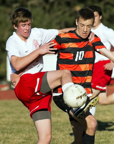 Collin Fredericks of Ferris, left, and Trevor Briggs of Lewis and Clark battle for control of the ball. (Colin Mulvany)