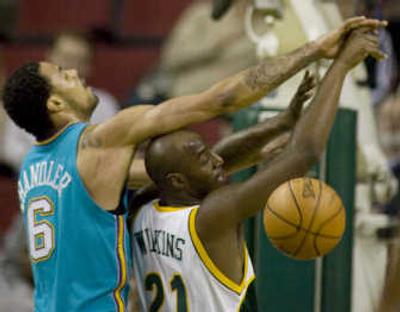 
New Orleans' Tyson Chandler, left, rejects a first-half shot by Seattle's Damien Wilkins on Wednesday night. Associated Press
 (Associated Press / The Spokesman-Review)