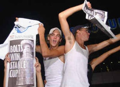 
Tampa Bay Lightning fans celebrate outside the St. Pete Times arena after the Lightning defeated Calgary in Game 7.
 (Associated Press / The Spokesman-Review)