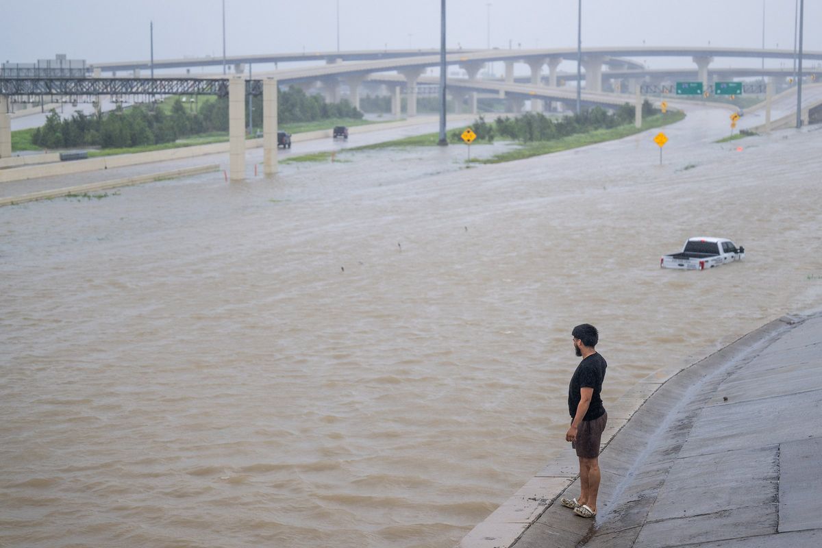 Above: A person looks out towards the flooded interstate after Hurricane Beryl swept through the area on July 8 in Houston. Left: Gary Rawls looks at his near-empty refrigerator while speaking about his situation from his apartment in the Kashmere Gardens neighborhood on July 11 in Houston.  (Brandon Bell)