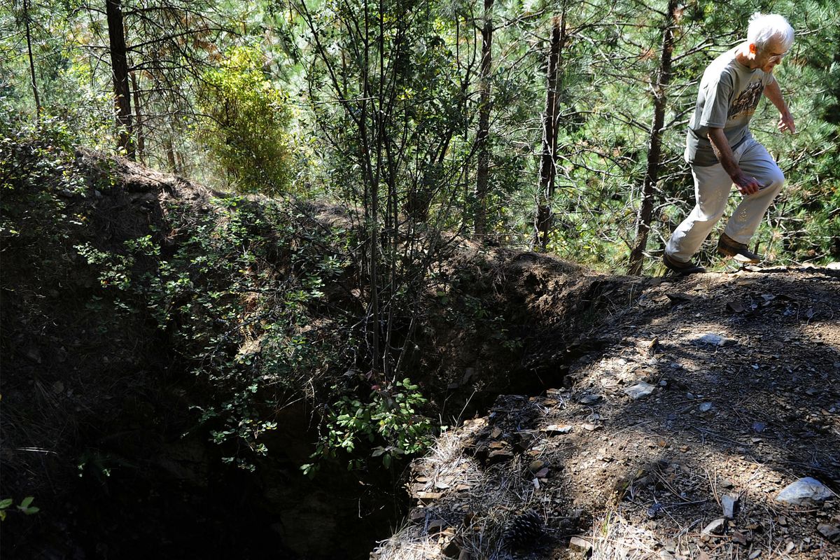 Historian Fred Bardelli, of Wallace, maneuvers past the nearly 300-foot-deep shaft at the Evolution Mine site on Tuesday. (Kathy Plonka)