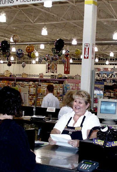 
Claudia Frasca waits on a customer at Fred Meyer. She has worked at the store in Coeur d'Alene since it opened.
 (Mike Kincaid/Handle Extra / The Spokesman-Review)