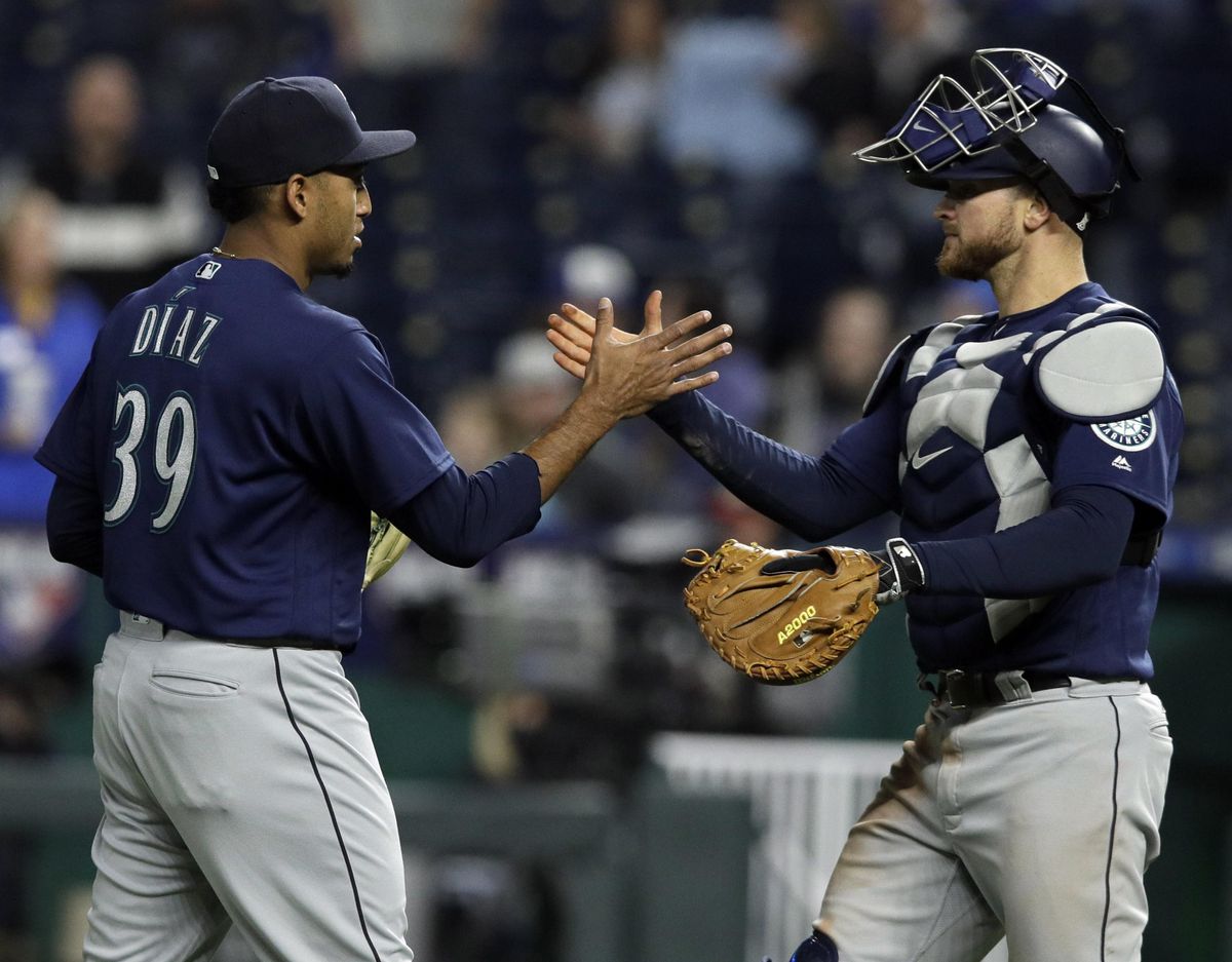Seattle relief pitcher Edwin Diaz  is congratulated by catcher Mike Marjama  following  Tuesday’s game in Kansas City, Missouri. The Mariners defeated the Royals 8-3. (Orlin Wagner / AP)