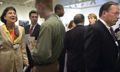 
Federal Way, Wash., Police Chief Anne Kirkpatrick, left, Spokane Deputy Police Chief Bruce Roberts, far right, and Linda Pierce, assistant criminal investigations bureau chief for the Seattle Police Department,  left of Roberts, talk with members of the  community during a reception at City Hall Monday. 
 (Holly Pickett / The Spokesman-Review)