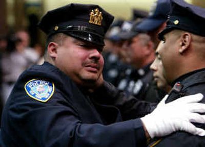 
Port Authority Police Detective William Jimeno, left, fights tears and embraces fellow officer Victor Otero during a ceremony Thursday for his final roll call in New York.
 (Associated Press / The Spokesman-Review)