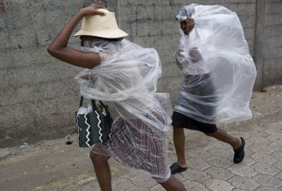 People dash through a downpour caused by Hurricane Gustav in Port-au-Prince, Haiti, on Tuesday.  (Associated Press / The Spokesman-Review)