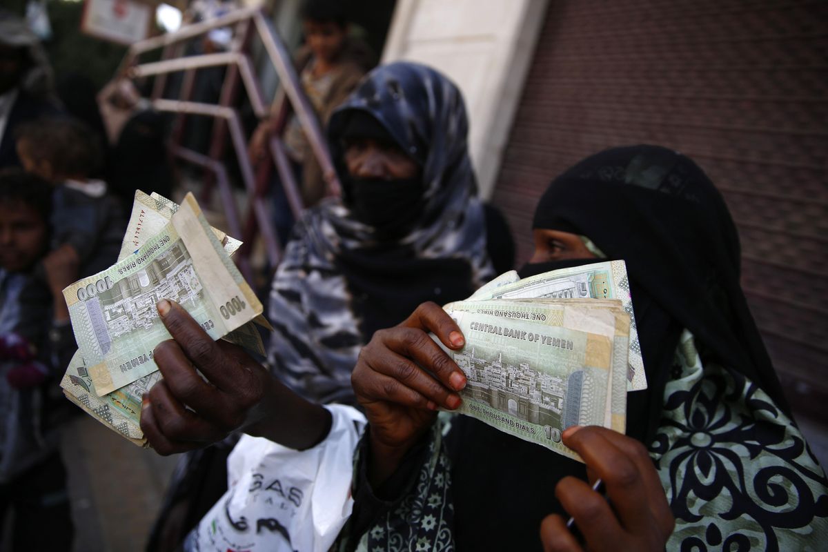 In this Nov. 14, 2015 photo, women display paper currency after receiving cash support from UNICEF, in Sanaa, Yemen. (Hani Mohammed / Associated Press)