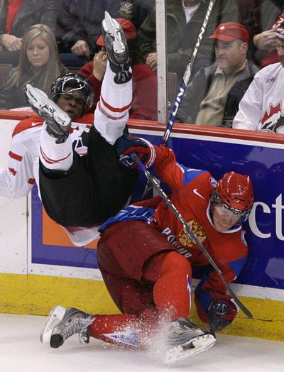 Canada’s P K  Subban is upended by Russia’s Sergei Andronov in the first period.  (Associated Press / The Spokesman-Review)