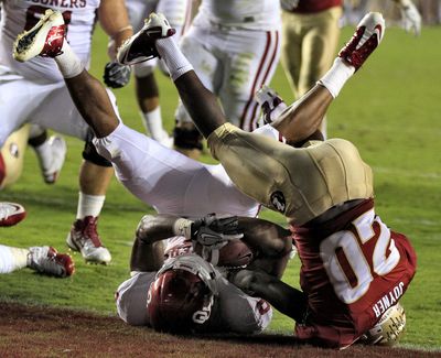 OU’s Dominique Whaley is upended by FSU’s Lamarcus Joyner at goal line. (Associated Press)