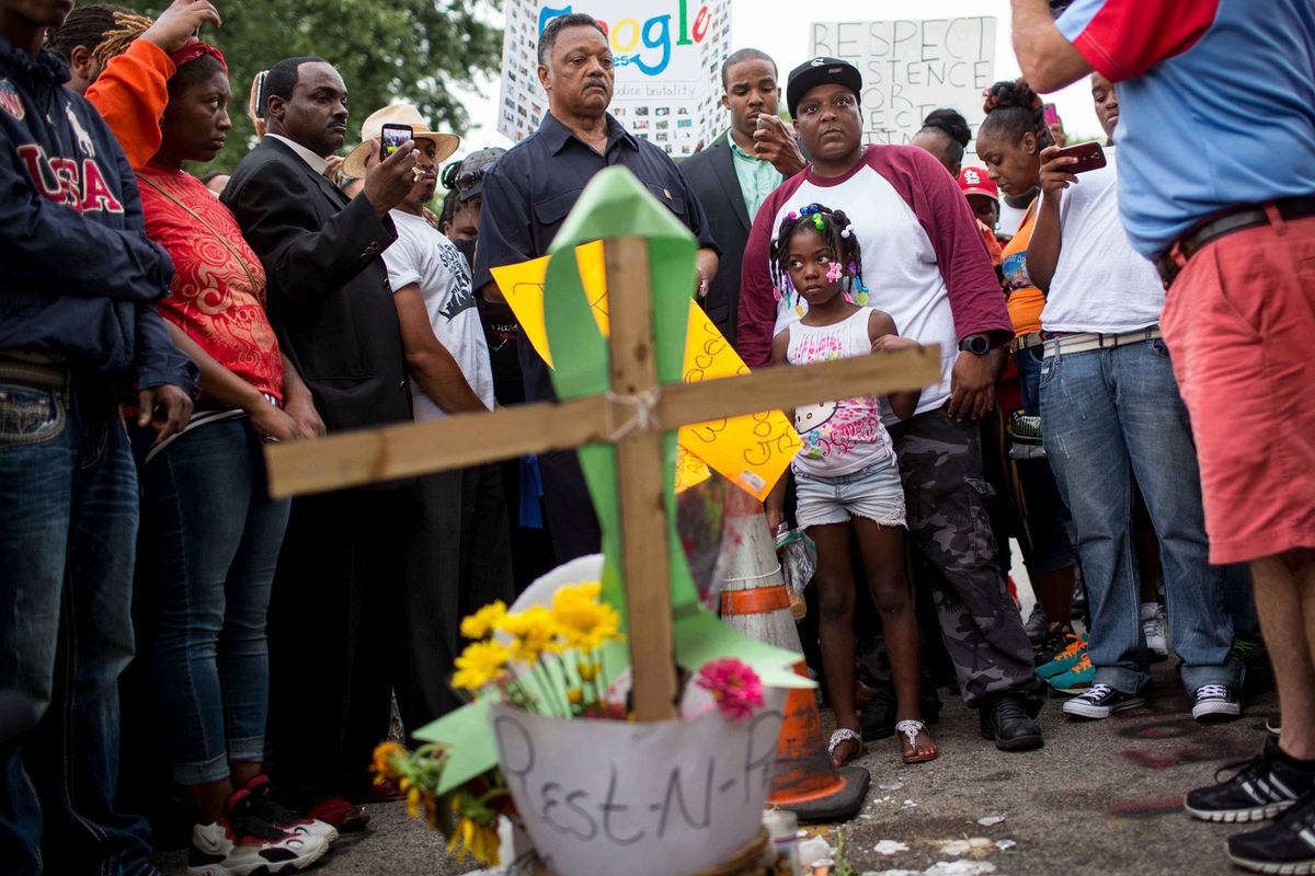 The Rev. Jesse Jackson visits an impromptu memorial for Michael Brown in Ferguson, Mo., on Aug. 15, 2014. Jackson, whose impassioned oratory and populist vision of a "rainbow coalition" of the poor and forgotten made him the nation