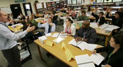 
Curriculum Specialist Martin Winchester, left, teaches during a Teach For America training session Tuesday in Houston. Teach For America is one of the country's hottest recruiters this spring. 
 (Associated Press / The Spokesman-Review)