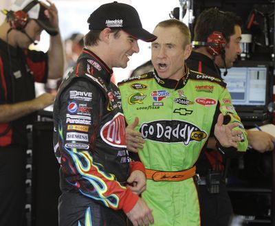 Drivers Jeff Gordon, left, and Mark Martin joke around in the garage area Friday. (Associated Press)