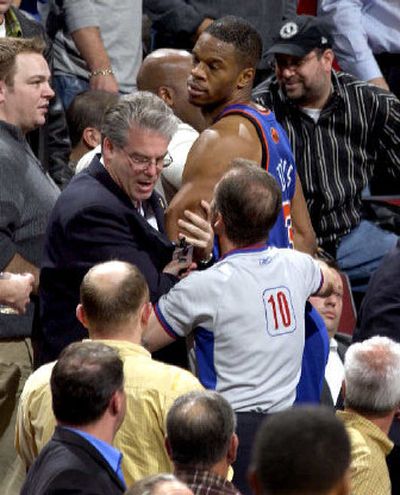 
New York's Antonio Davis, top, is escorted out of the stands after being ejected.
 (Associated Press / The Spokesman-Review)