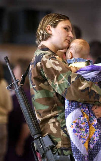 
Michelle Cooper holds her 7-month-old baby Zara before deploying with the Idaho National Guard from Geiger Field. 
 (Christopher Anderson/ / The Spokesman-Review)