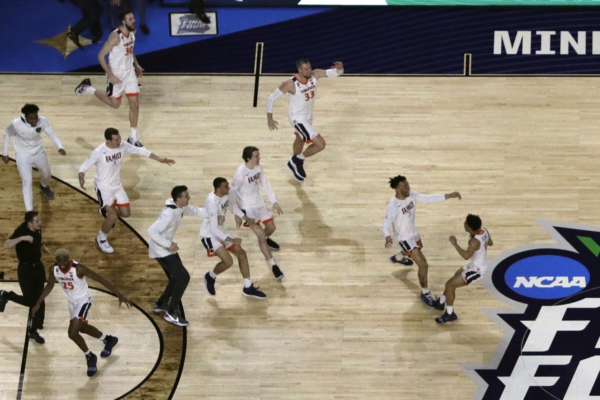 Virginia players celebrate after defeating Texas Tech 85-77 in overtime in the championship game of the NCAA Tournament on Monday in Minneapolis. (Morry Gash / Associated Press)