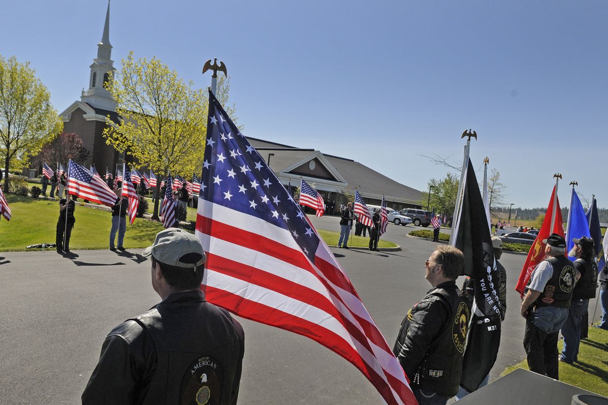 An honor guard lines the driveway outside the Church of Jesus Christ of Latter-day Saints on Melville Road in Cheney on Saturday for the memorial service of Sgt. 1st Class Clifford Beattie, who was killed in action in Iraq. (Christopher Anderson)