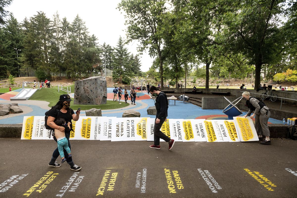 During the 100th consecutive day of demonstrations in Portland, Ore., the stenciled names of Black people who died line a pathway on Saturday, Sept. 5, 2020. The protests, which began over the killing of George Floyd, have led to two deaths and frequent clashes between protesters and law enforcement.  (Noah Berger)