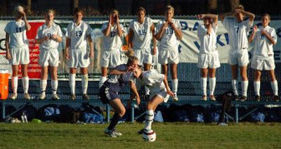 Coeur d'Alene teammates cheer as Kaylee Nowoj, right, battles Lake City's Joanna Clark for the ball during Wednesday's state-qualifying soccer match. 
 (Jesse Tinsley / The Spokesman-Review)