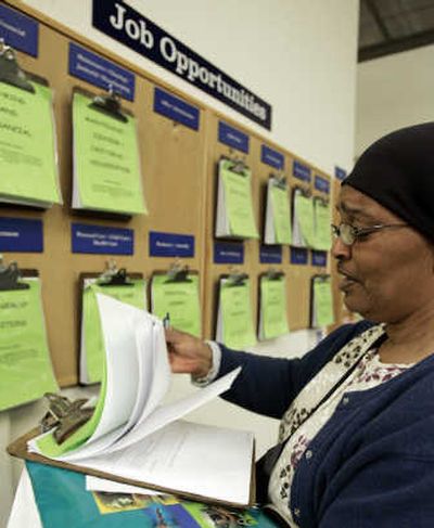 
Mary K. Davis looks through the latest job listings Friday at the Oakland Private Industry Council Inc. in Oakland, Calif. Associated Press
 (Associated Press / The Spokesman-Review)