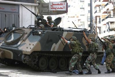 
Lebanese soldiers take up positions  during clashes with   militants  in  Tripoli on Sunday. 
 (Associated Press / The Spokesman-Review)