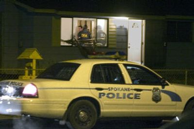 Spokane Regional Drug Task Force personnel raid a house on East Fourth Avenue behind Fred Meyer on Tuesday evening.
(Christopher Anderson / The Spokesman-Review)