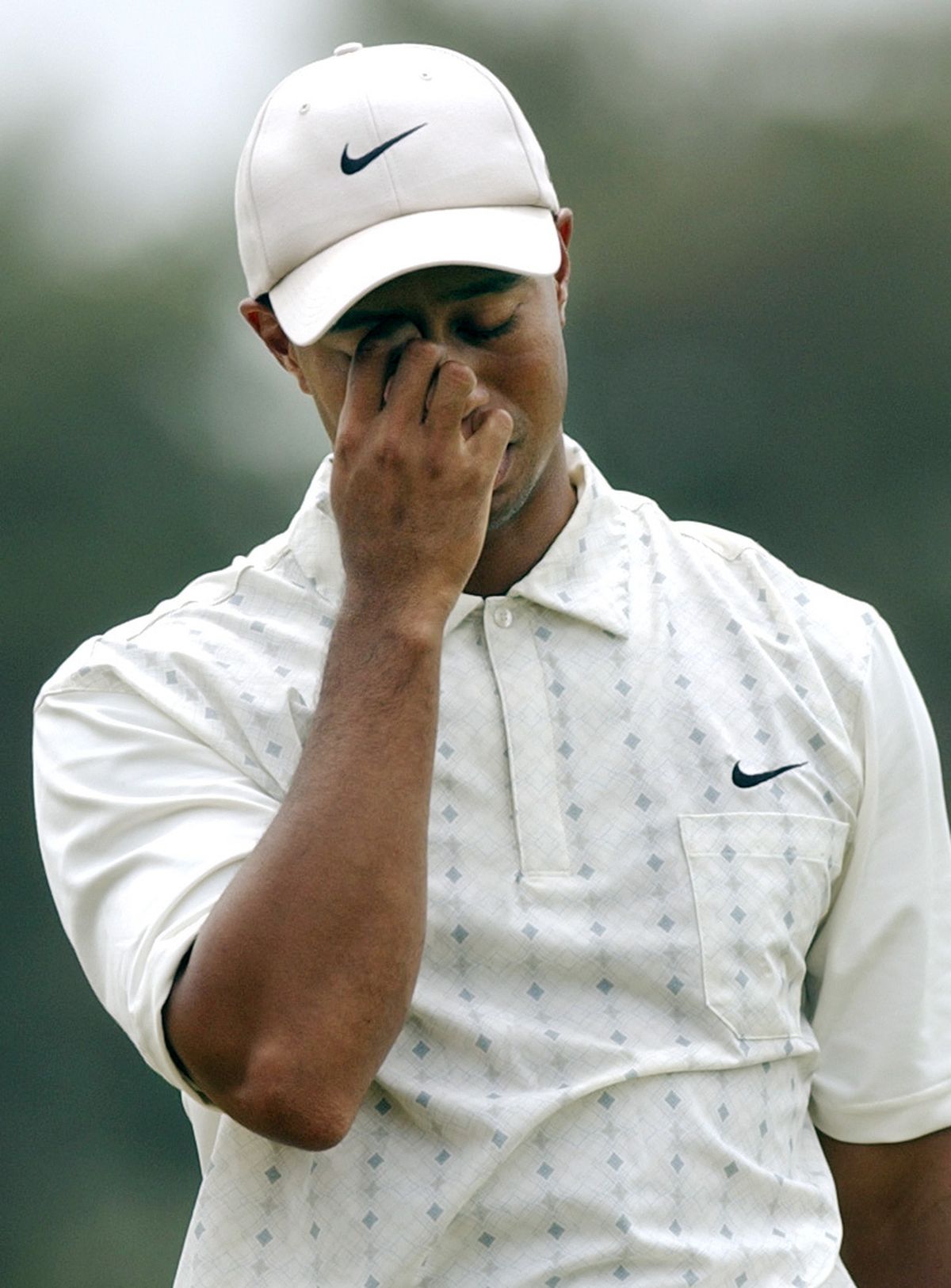 FILE - In this Saturday, June 19, 2004, file photo, Tiger Woods reacts on the fifth fairway after his shot toward the green during the third round of the U.S. at Shinnecock Hills Golf Club in Southampton, N.Y. Nike forgave a contrite Tiger Woods after his infidelity was exposed. It welcomed back an apologetic Michael Vick once he served time for illegal dog-fighting. But the company dropped Lance Armstrong, Wednesday, Oct. 17, 2012, faster than the famed cycler could do a lap around the block. (Charles Krupa / Associated Press)