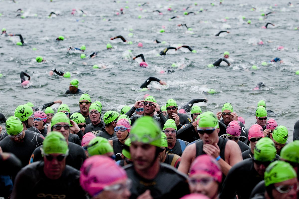 Triathletes briefly emerge from Lake Coeur d’Alene before re-entering for the second half of the swim portion of the Coeur d’Alene Ironman on Sunday. (Tyler Tjomsland)