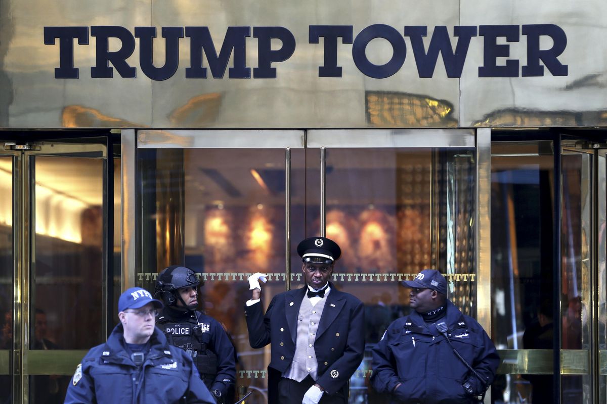 A doorman, center, talks with security personnel at the front entrance of Trump Tower in New York on Thursday, Nov. 17, 2016. (Seth Wenig / Associated Press)