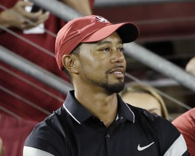 In this Oct. 8, 2016, file photo, golfer Tiger Woods, left, watches an NCAA college football game between Stanford and Washington State, in Stanford, Calif. The comeback of Tiger Woods is going to have to wait at least two more months. Three days before he was to return at the Safeway Open, Woods said he wasnt ready to return against PGA Tour competition. Along with pulling out of the Safeway Open, Woods said Monday he was withdrawing from the Turkish Airlines Open next month. (Marcio Jose Sanchez / Associated Press)