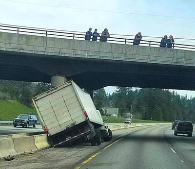 A truck driver, eastbound on I-90 at 7th Street overpass Wednesday afternoon, snarled traffic by crashing into the median. No injuries were reported. Officer had to prevent the Lookie Lous above from parking on the overpass to watch the action. (Tom Torgerson/Facebook photo)