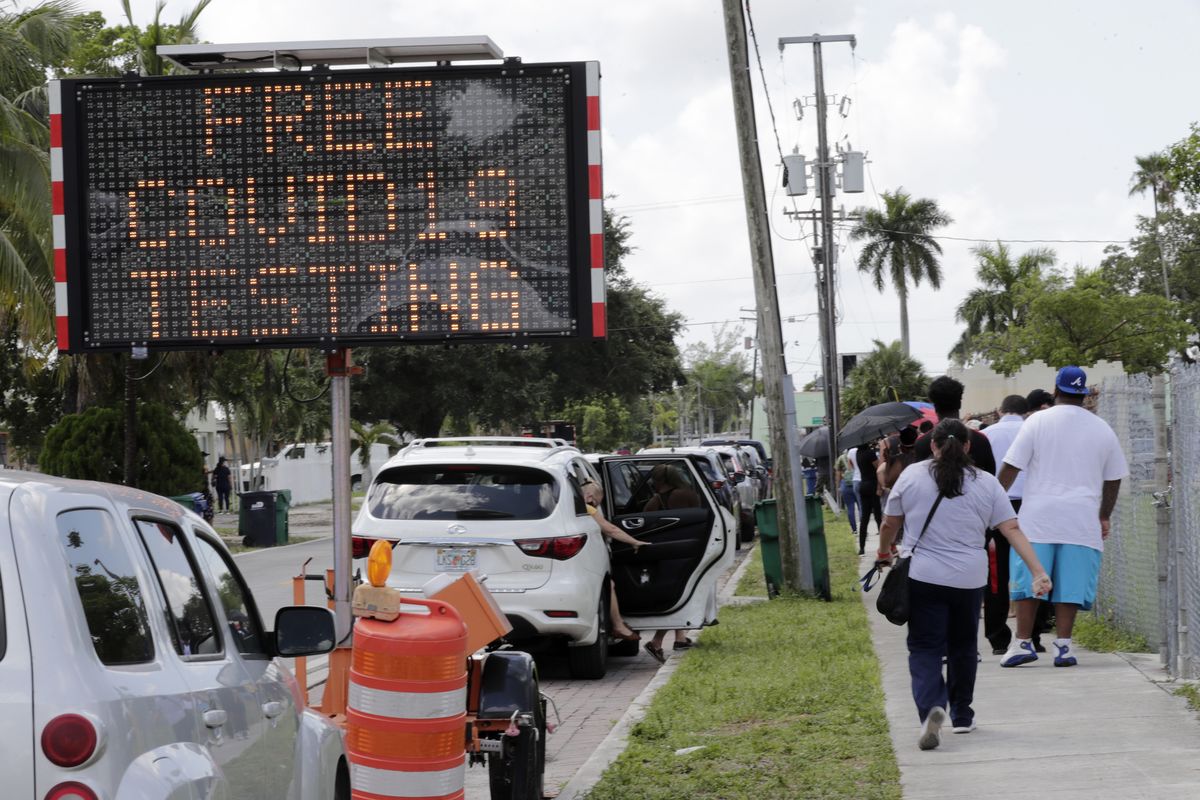 People wait in line outside a COVID-19 testing site during the coronavirus pandemic on July 16 in Opa-locka, Florida.  (Lynne Sladky/Associated Press)