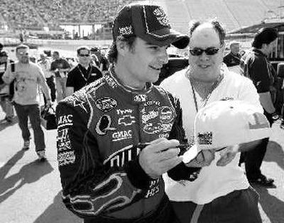
Jeff Gordon signs autograph after taking pole for Sunday's race. 
 (The Spokesman-Review)