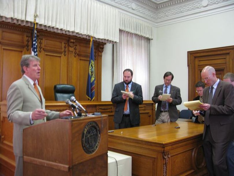 Gov. Butch Otter answers questions from reporters after a bill-signing ceremony on Friday. Otter threw cold water on an idea being promoted by House GOP leaders as an alternative to a gas-tax hike - instead imposing a conditional, economically-triggered shift from the state's general fund to pay for road work. (Betsy Russell / The Spokesman-Review)