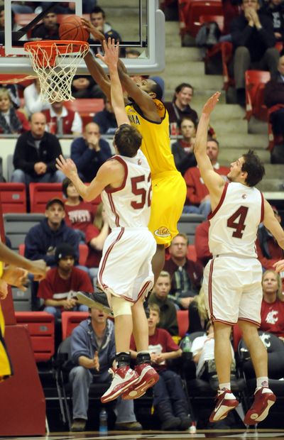 With a little more than a minute to go and Cal ahead by four, Cal's Patrick Christopher takes a sky high alley oop and throws it down over Washington State's Caleb Forrest (#52) and Nikola Koprivica, right, to end WSU's hopes for a quick comeback . (Jesse Tinsley / The Spokesman-Review)