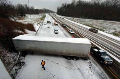 
A jackknifed tractor-trailer blocks northbound lanes of Interstate 77 in Charlotte, N.C. Saturday. A mixture of snow and sleet blanketed the area causing delays for weekend travelers. 
 (Associated Press / The Spokesman-Review)