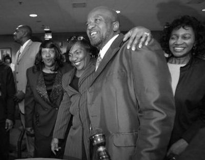 James Giles is surrounded by family after a judge recommended his exoneration Monday in Dallas. Giles, who spent 10 years in prison after a rape conviction, is hugged by his sister Virginia Garrett.
(Associated Press / The Spokesman-Review)