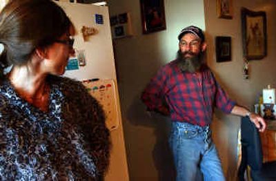 
A substitute teacher who's just scraping by, Betsy Rosenberg talks with husband Jerry Lang at home.
 (Kathy Plonka / The Spokesman-Review)